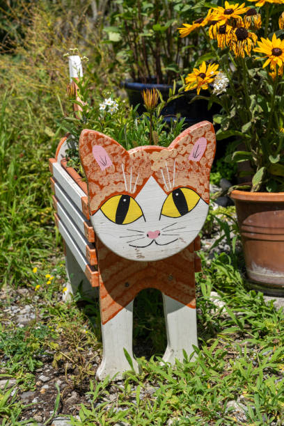 Adorable orange cat flower planter on a patio