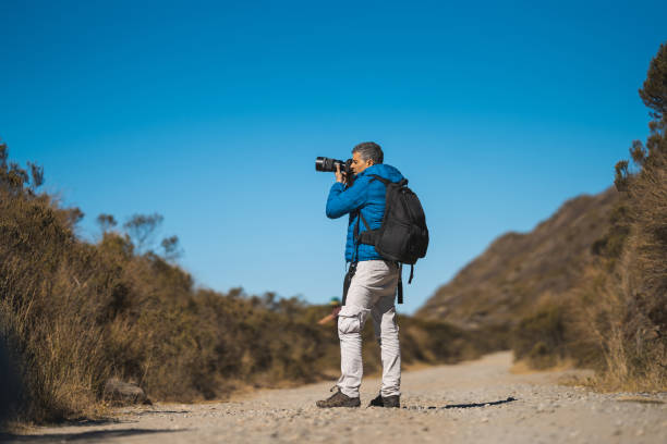 istock Tourist taking photo on a mountain trail 2166771456