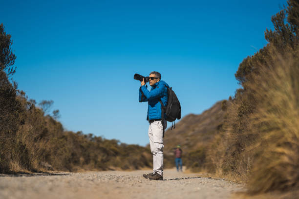 istock Man taking pictures on a mountain road 2166771477