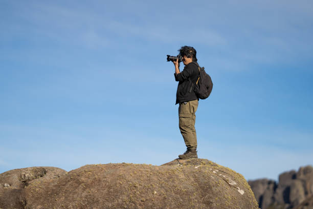 istock Photographer taking picture on mountain peak 2166771525