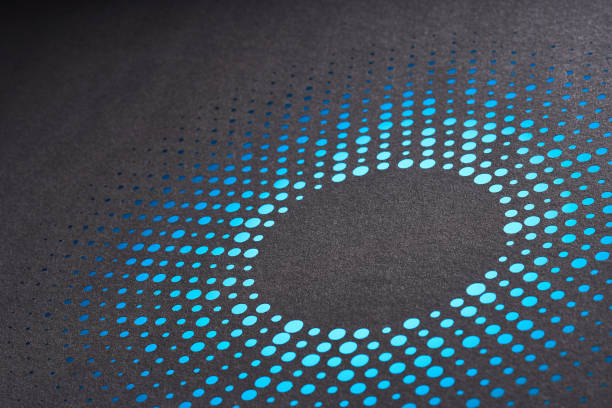 istock Intricate circular gradient design of perforated blue paper dots on a dark textured background 2166772180