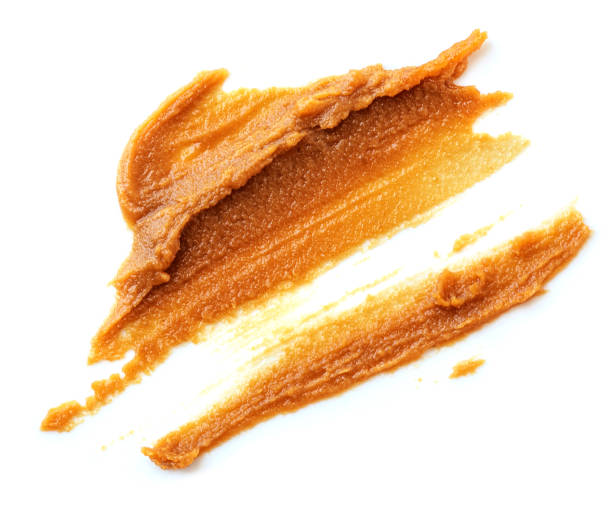 istock Peanut butter crunch smear isolated on a white background. Peanut texture macro 2166775521