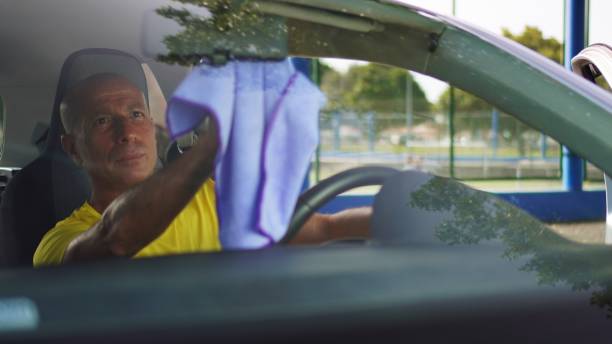 istock Cleaning the Rearview Mirror - View Through the Windshield 2166775601
