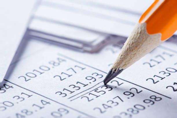 Checking the value of securities. Pencil, share listing and checking financial chart. Concept of banking, financial report and financial audit.