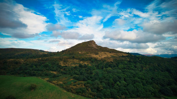 istock Scenic view of a lush green hill under a dynamic sky 2166777286