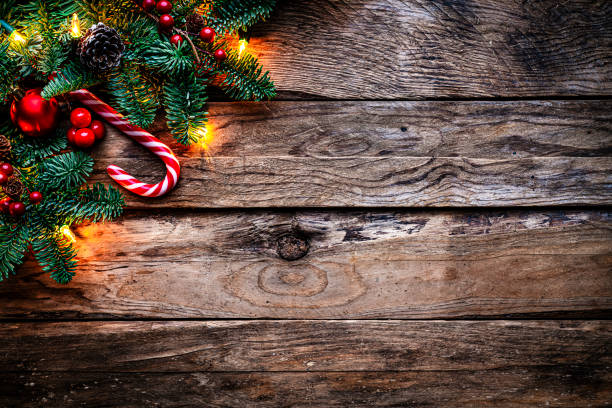 istock Christmas decor on old wood background with string lights, fir tree and candy cane Copy space 2166777579