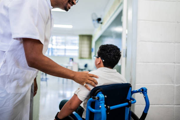 istock Teachet talking to wheelchair student entering on classroom at school 2166778346