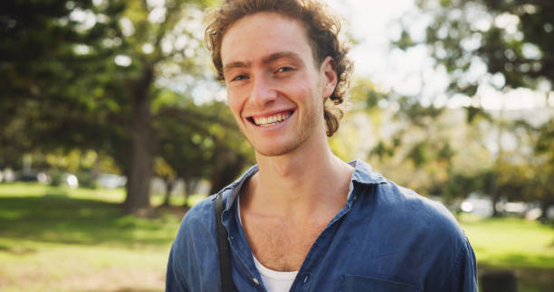 istock Student, happy and portrait in park for study break, knowledge and academic opportunity outdoor. Man, smile and face at campus, university or college for education, learning and school 2166780182