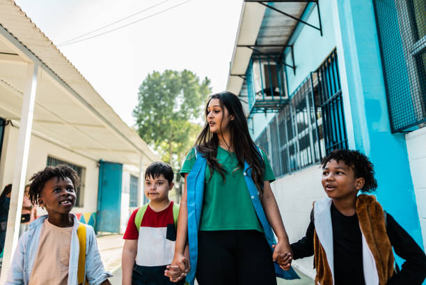 istock Teacher walking with students on schoolyard 2166780440