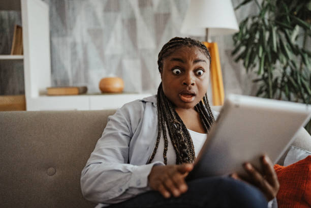 istock Shocked woman looking at tablet with wide eyes 2166780756