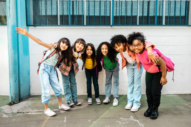 Portrait of a students embracing on schoolyard