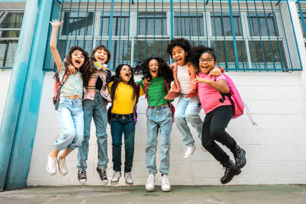 istock Portrait of a students jumping on schoolyard 2166780836