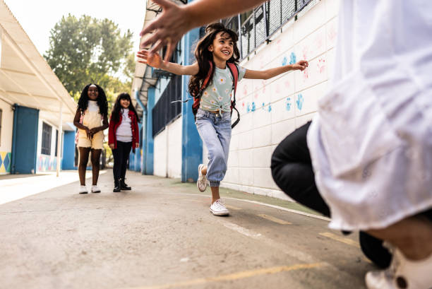 istock Student running to embrace teacher on schoolyard 2166780973