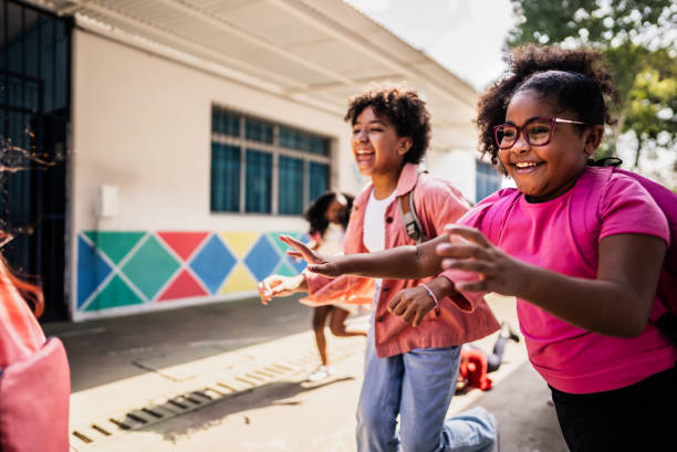 istock Student running with friends on schoolyard 2166781140