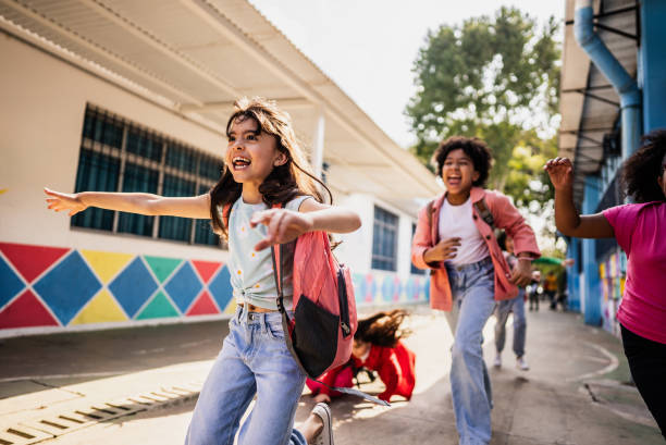 istock Student running with friends on schoolyard 2166781141