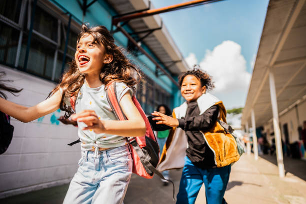 istock Student running with friends on schoolyard 2166781149
