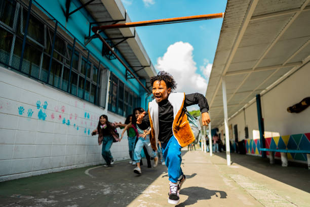 istock Student running with friends on schoolyard 2166781154