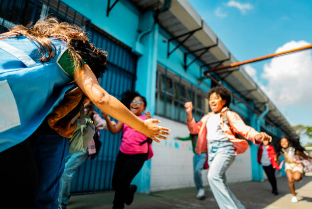 istock Rear view of a teacher embracing students on schoolyard 2166781198