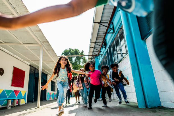 istock Students running to embrace teacher on schoolyard 2166781262