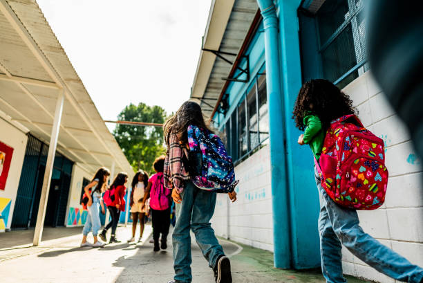 istock Rear view of students walking on schoolyard 2166781264