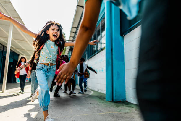 istock Students running to embrace teacher on schoolyard 2166781266