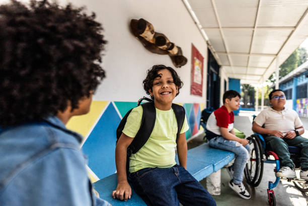 istock Schoolboy talking with friend on schoolyard 2166781285