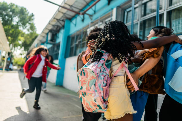 istock Students embracing teacher on schoolyard 2166781424