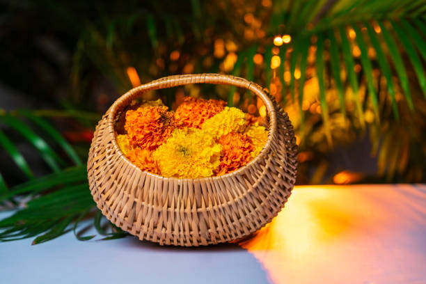 Onam flower decoration, marigold flower in a basket, Beautiful wicker basket with flowers on it, Diwali and Pongal festival concept image