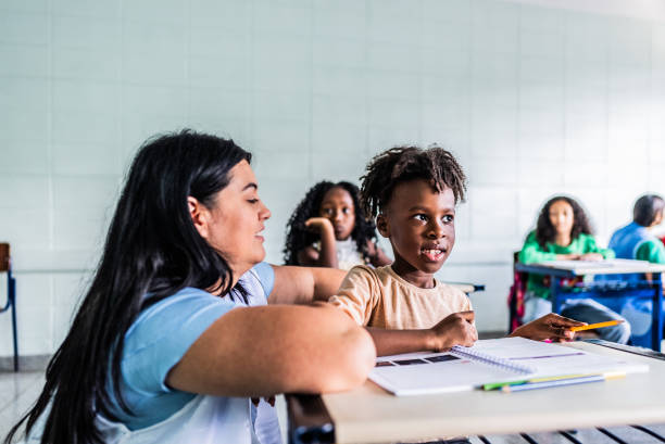 istock Teacher teaching student on classroom at school 2166782325
