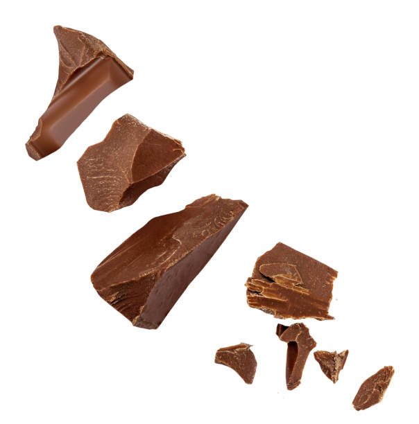 istock  Levitating bitter chocolate chunks isolated on white background. Flying Chocolate pieces, shavings and cocoa crumbs Top view. Flat lay 2166782592