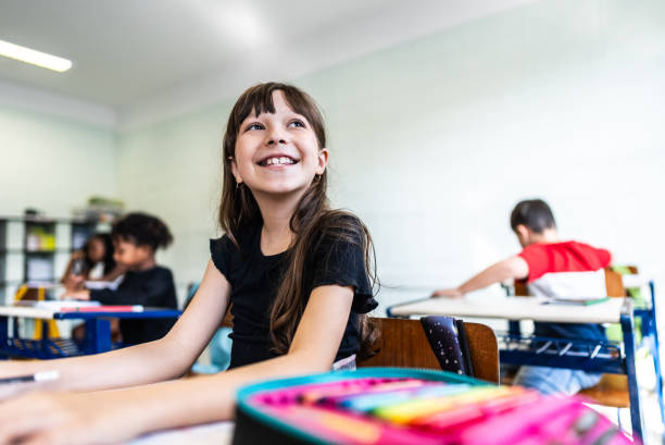 Schoolgirl contemplating on classroom at school
