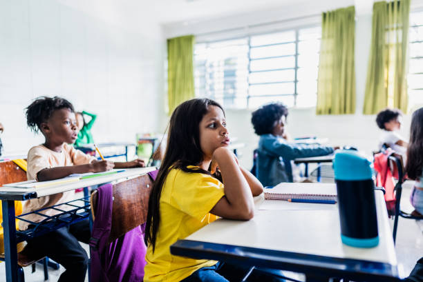 istock Schoolgirl studying on classroom at school 2166782729
