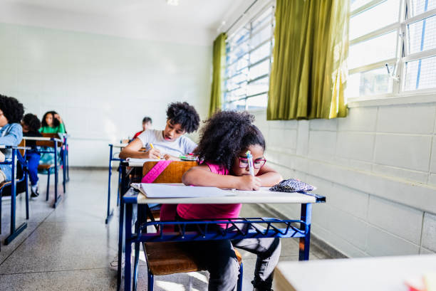 istock Schoolgirl studying on classroom at school 2166782747