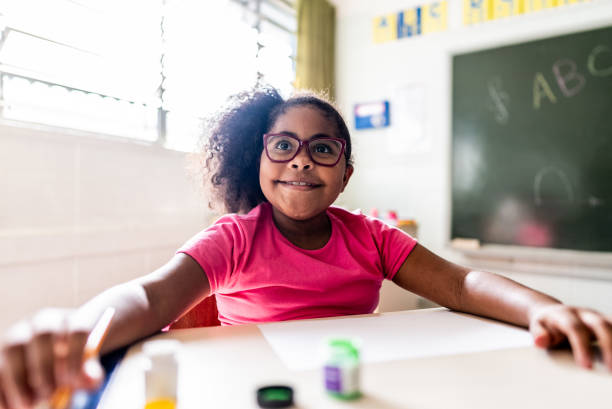 istock Happy schoolgirl on classroom at school 2166782759