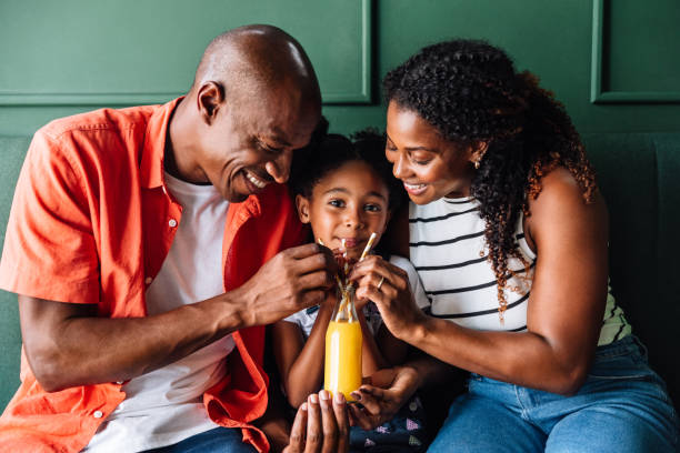 Happy black family drinking juice