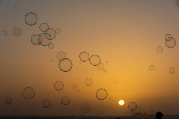 istock Lots of soap bubbles in the sky at sunset 2166784365