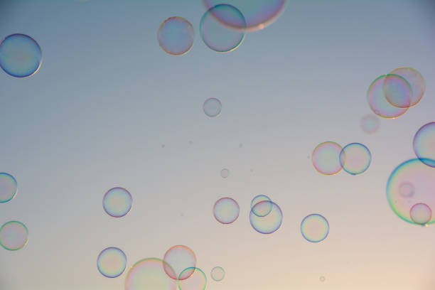 Many colorful soap bubbles float in the sky
