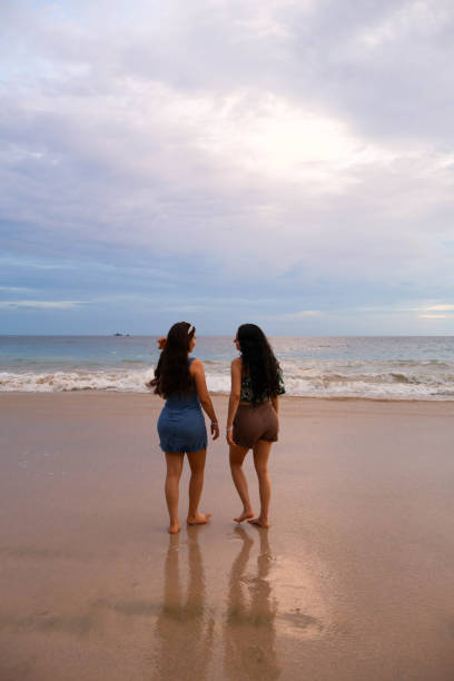 istock Friends walking in the beach 2166785702