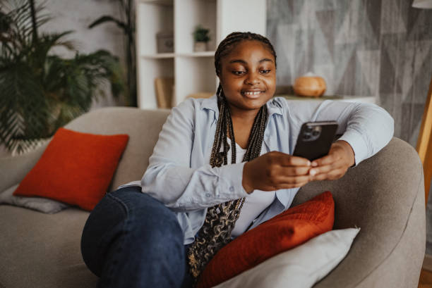 istock Woman enjoying her smartphone time on the sofa. 2166785723