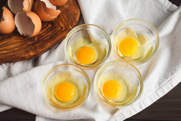 istock Eggs Cracked into Small Glass Bowls 2166787267