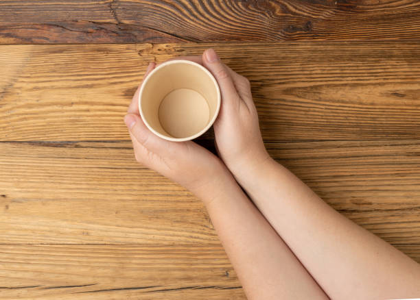istock Hand Holds Cup, Empty Paper Cup in Hands, Coffee Mug, Teacup, Hot Beverage Mockup, Cup in Arms 2166787570