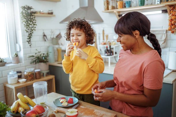 istock Mother and son having fun while making healthy fruit meal in a domestic kitchen 2166788280