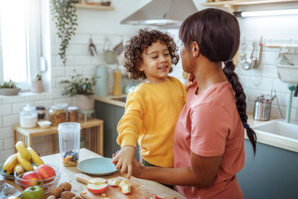 istock Mother and son having fun while making healthy fruit meal in a domestic kitchen 2166788301