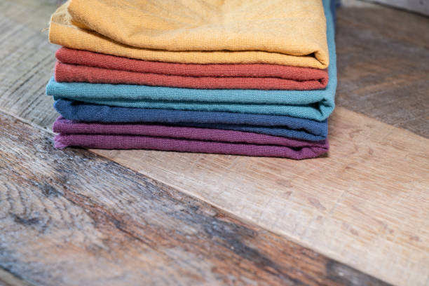 Kitchen towels stacked on a wooden background with a copy of the space