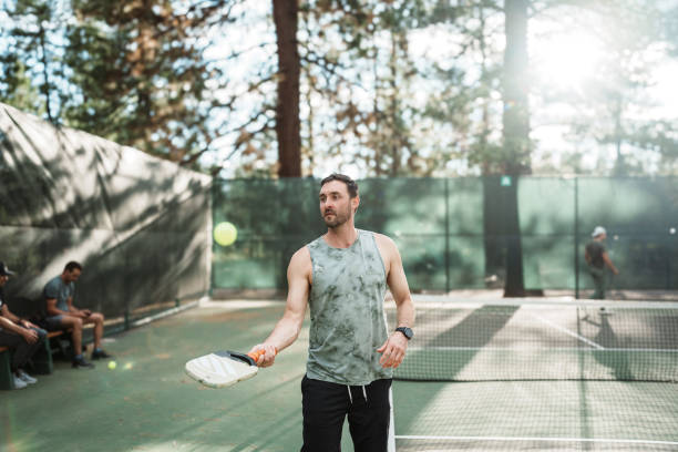 istock Man juggles ball on a pickleball paddle 2166789439
