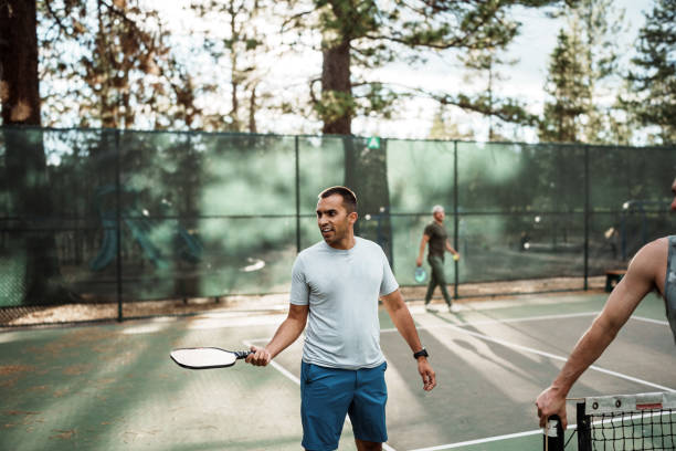 istock Man juggles ball on a pickleball paddle 2166789444