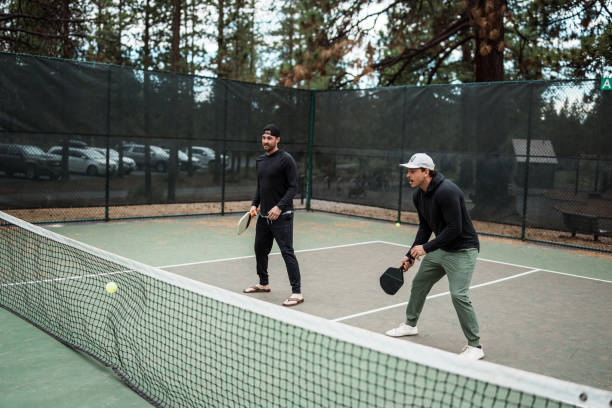 istock Two men ready to hit the ball while playing pickleball 2166789447