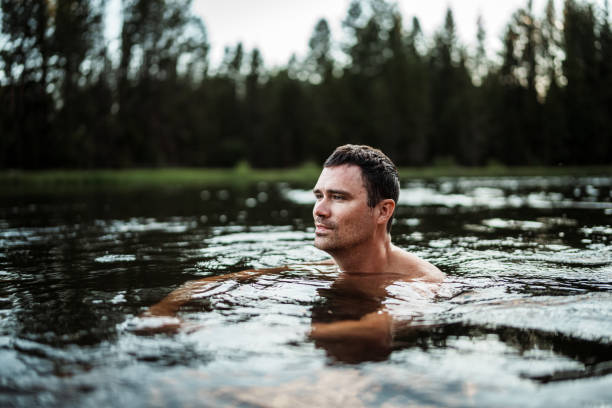 istock Man swims in a tranquil river in Central Oregon 2166789464