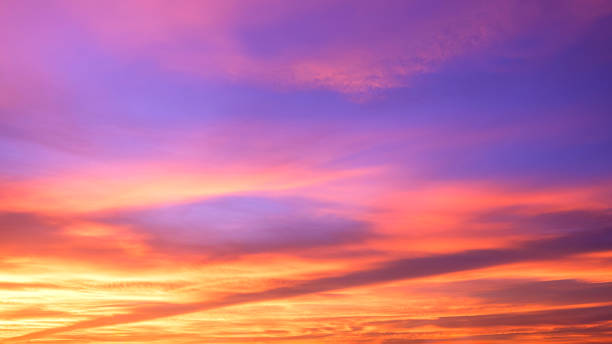 istock Evening sky background after sundown with colorful yellow and orange sunlight clouds on blue dusk sky 2166790936