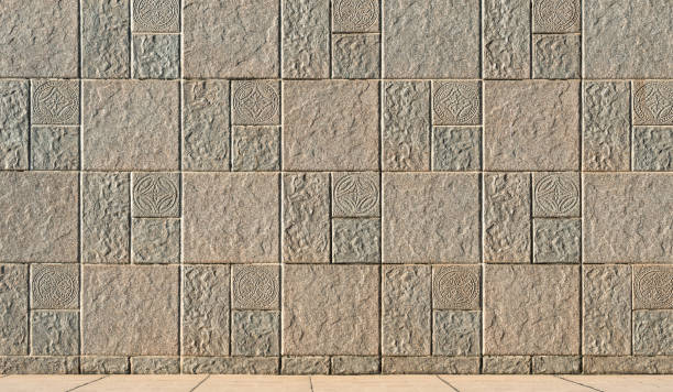 istock Exterior beige stone tile wall background with abstract pattern and rough texture surface on pavement floor 2166791378